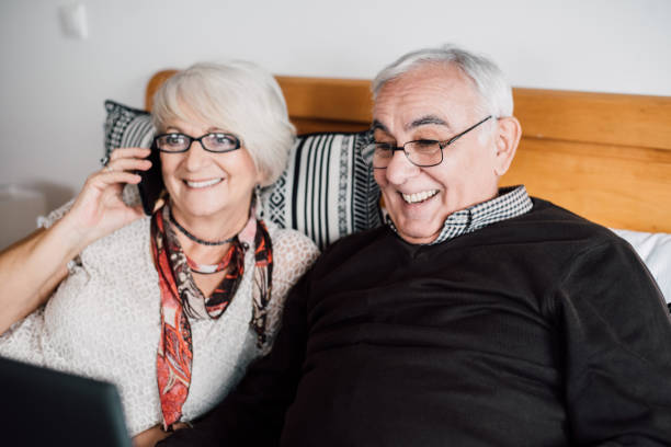 istock Senior couple using smart phone and laptop 942190072