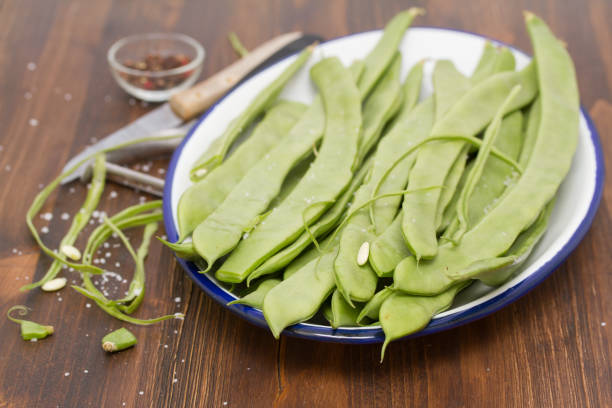 istock fresh green beans on dish on wooden background 942190314