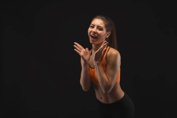 istock Athletic woman having fun on black background 942190754