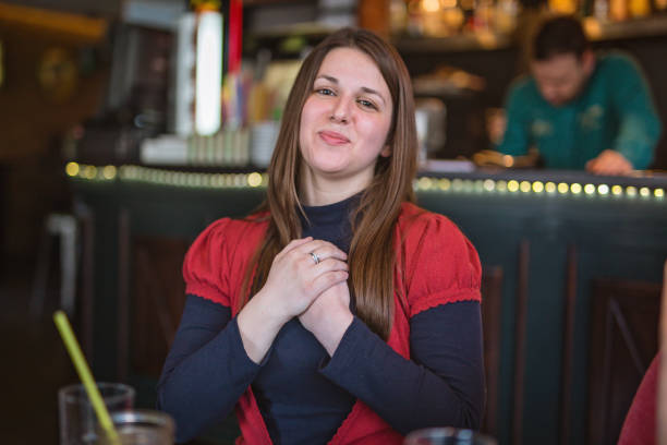 Lovely woman spending time enjoying coffee at the cafe and using sign language as a way of communication.
