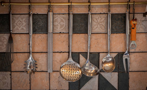 istock image of kitchen utensils hanging on the wall 2 942192474