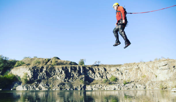 istock Jump off a cliff into a canyon with a rope. 942196566