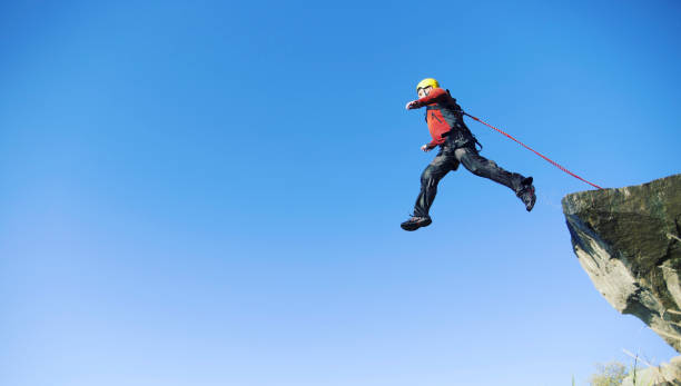 istock Jump off a cliff into a canyon with a rope. 942196574