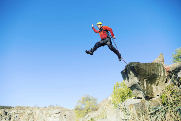 istock Jump off a cliff into a canyon with a rope. 942196598