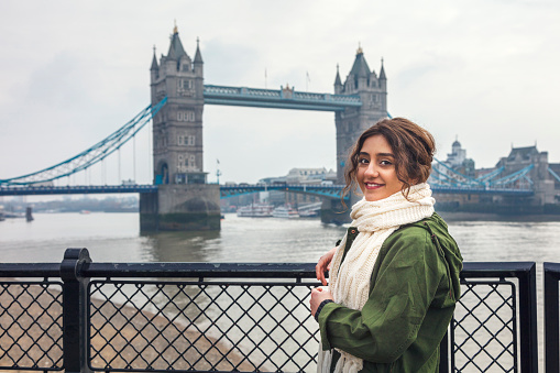 Young woman looking busy and energetic cityscape of London, England