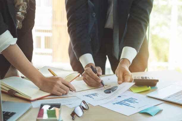 istock Business Team analyzing financial document and calculator on workplace - Corporate Organization Meeting Concept 942199758