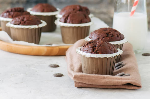istock Rich chocolate zucchini muffins with chocolate chips. Close up. White stone background. 942201100