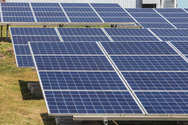 istock Close up rows array of polycrystalline silicon solar cells or photovoltaics in solar power plant 942204468