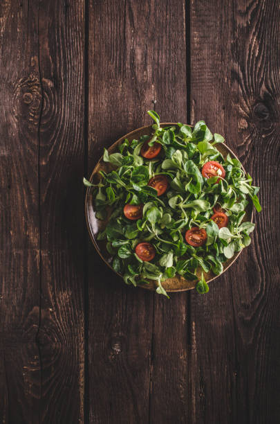 istock Lamb lettuce salad, tomatoes and herbs 942205350