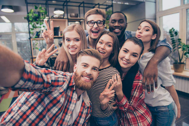 istock Group of happy cheerful best friends making selfie 942209974