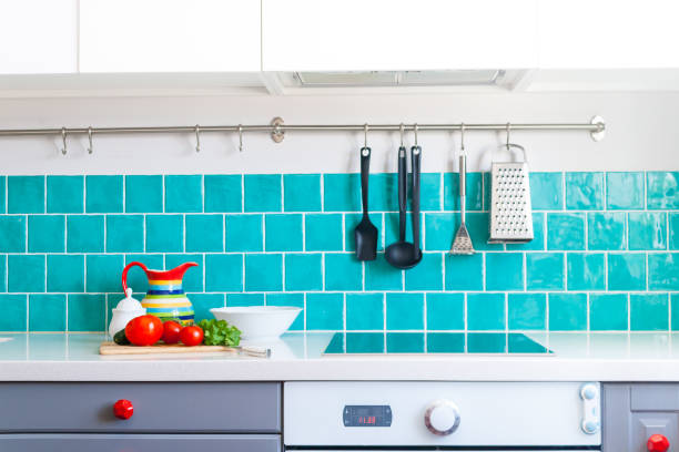 istock Kitchen features dark gray flat front cabinets paired with white quartz countertops and a glossy blue care tile. 942210316