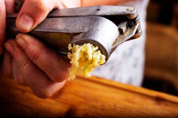 Crushing garlic stock photo