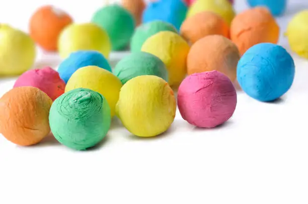 close on colorful paper balls for party  on white background