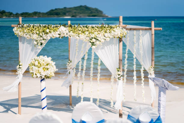 istock Beautiful beach wedding arch setting with flowers decoration, panoramic ocean view 942216470