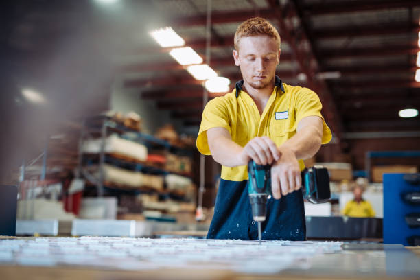 istock Worker in factory fixing electric power line 942216814