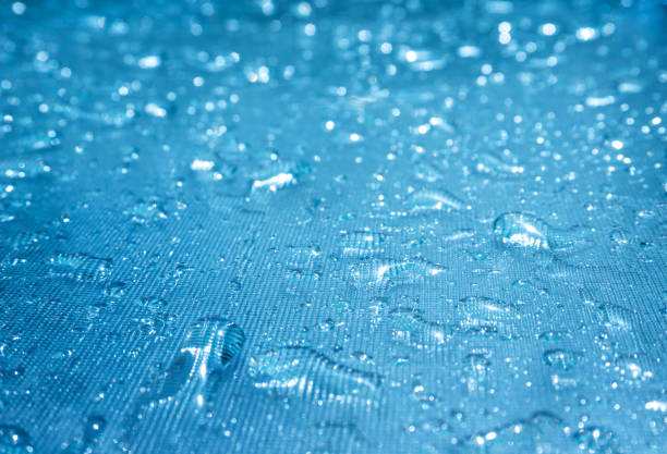 istock Rain drops on the blue glass bokeh background, shiny raindrops on a glass surface, water drops in a swimming pool closeup 942217938