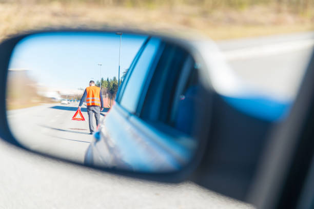 istock A man putting a warning triangle behind his car 942218028