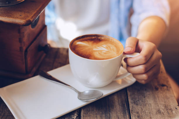 istock female hands holding Latte art, coffee cup. 942220788