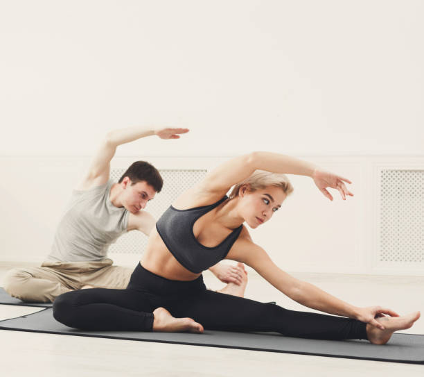 istock Fitness couple stretching at white background 942221446