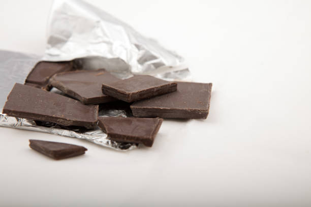 istock Chocolate bar close Up, in silver foil on gray background 942224786