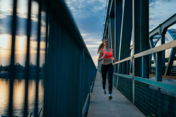 istock Jogging across the bridge in the evening 942225908