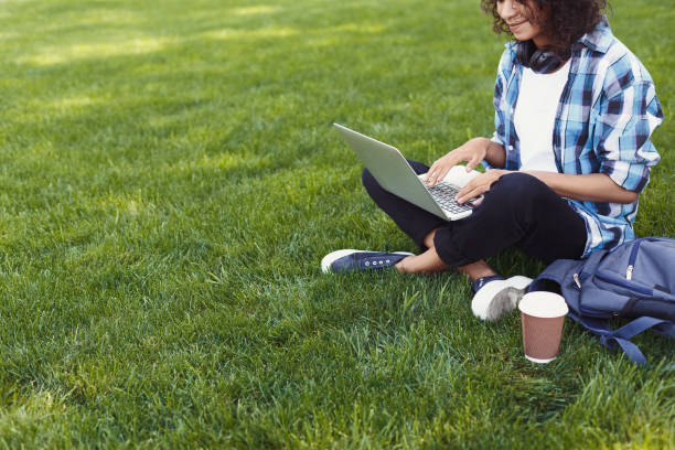 istock Unrecognizable black woman using laptop in park 942226206