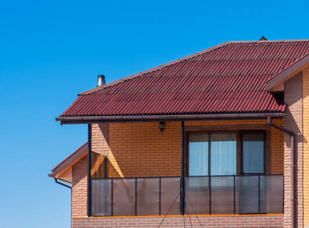 istock Modern cottage with balcony and brick facade. Blue sky background 942226366