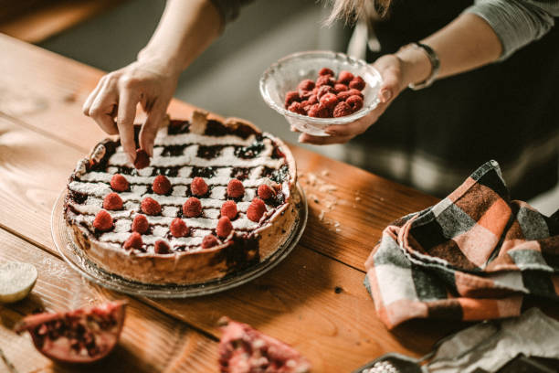 istock Young woman decorating cake 942226428