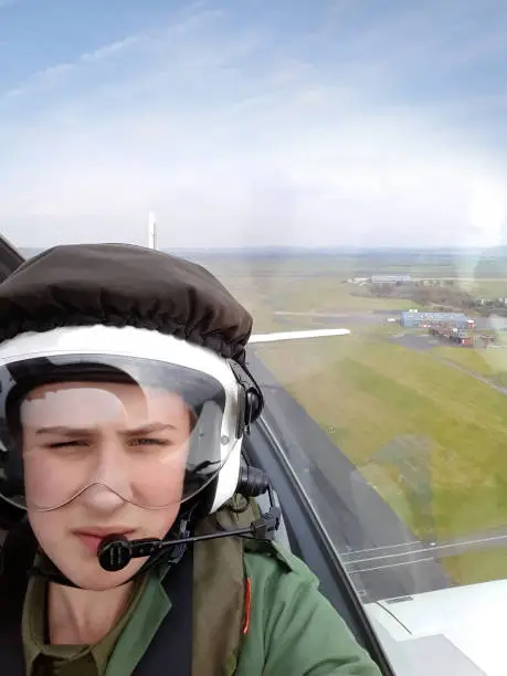 Teenage RAF airforce cadet taking a flight in a small aeroplane
