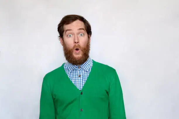 Photo of Bearded man opens his mouth in surprise