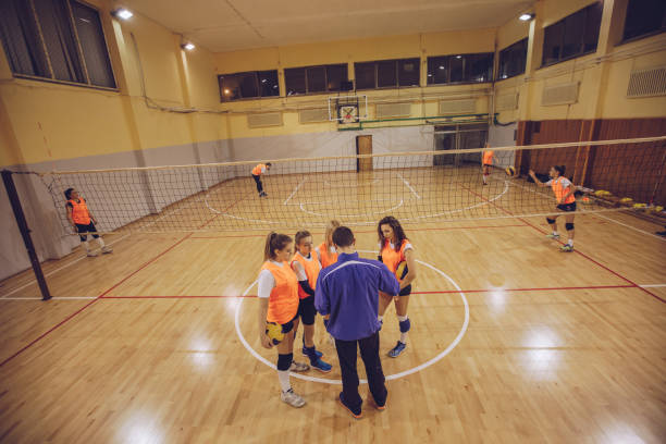 istock Coach and female volleyball players making strategy 942229374
