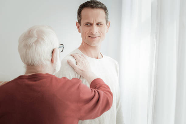 istock Interested handsome man standing and looking at another man. 942229576