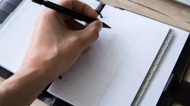 istock Man is going to write something on his notebook. Top view, flat lay. In Search Of Inspiration. A man with an empty notebook. 942229594