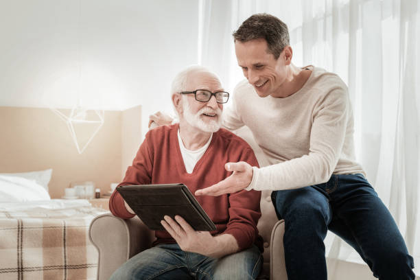 istock Funny pleasant men sitting and overlooking the tablet. 942230532