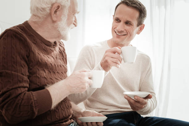 istock Interested attentive man holding a cup and listening. 942234656