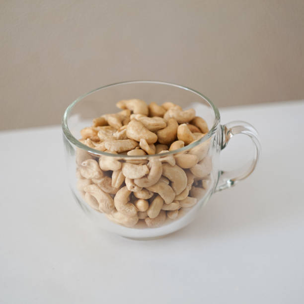 орехи кешью в кружке - cashew beer nuts nut food стоковые фото и изображения
