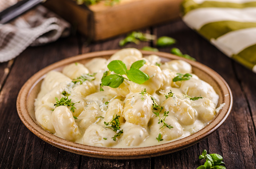 Cheese gnocchi with blue cheese sauce and galic, herbs on top, delish food
