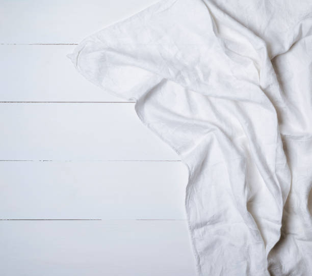 istock white textile napkin on a white wooden background 942250076