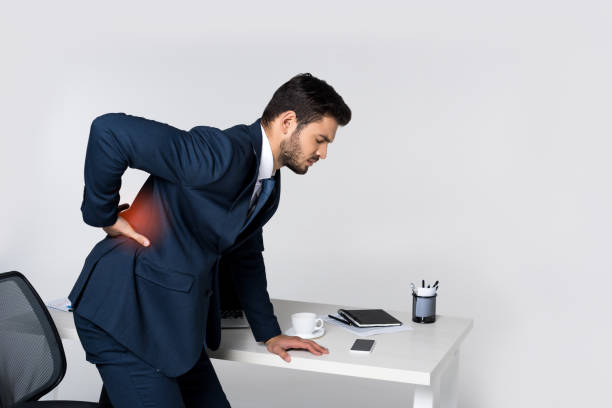 istock overworked young businessman suffering from headache while sitting at workplace 942250510