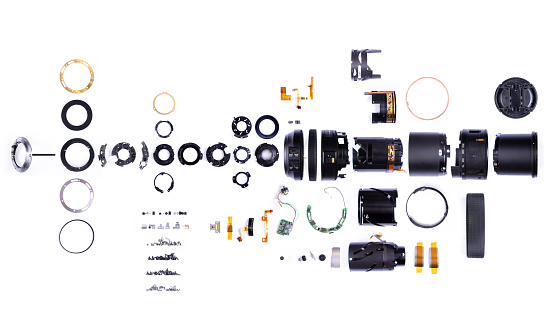 Exploded view of all parts of a DLSR zoom lens\n+ Nikon logo, words and writing on chips removed
