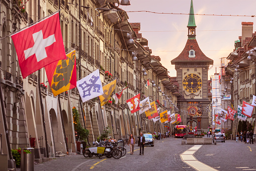 Kramgasse (street) in the medieval old city of Bern in Switzerland, with the 13th century Zytglogge clock tower at the end of the street.