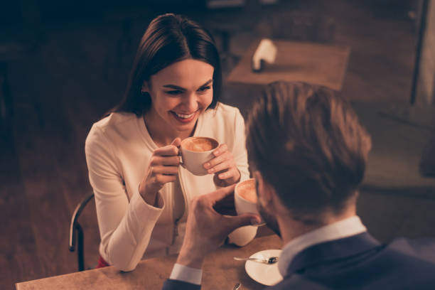 istock Cheerful romantic couple sitting in a cafe with coffee 942251618