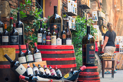 A variety of wines from the region (Tuscany) displayed outside a wine store and wine tasting business along a street in the town of Montepulciano, Italy.