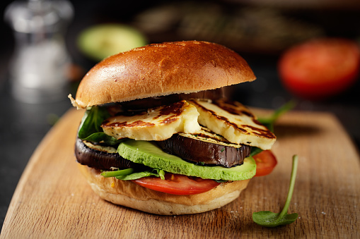 Home made freshness grilled aubergine,halloumi cheese with avocado, tomato, and spinach burger
