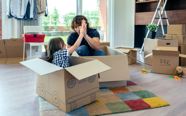 istock Father and son giving five after cardboard car racing 942256392