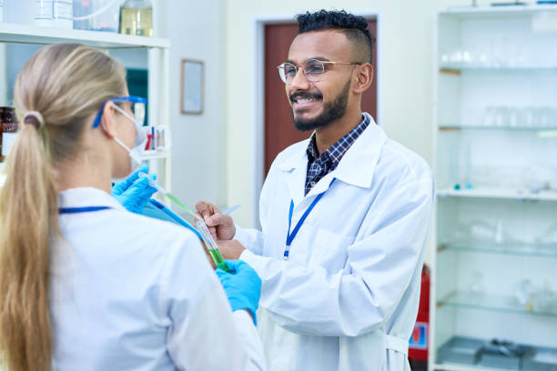 istock Cheerful laboratory employees discussing experiment 942261588