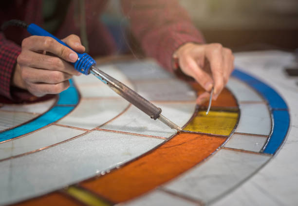 Student working on stained glass project. Student working on stained glass project. stained glass photos stock pictures, royalty-free photos & images