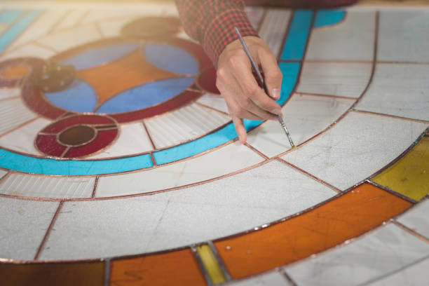 istock Artist working in stained glass studio. 942262428