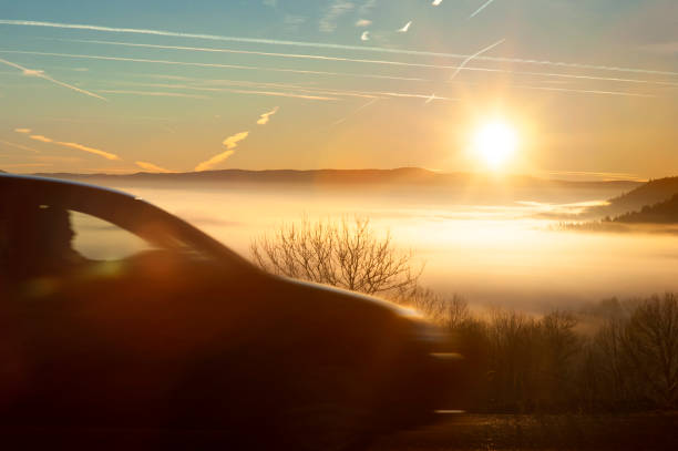 istock Car on a road at sunset 942267066