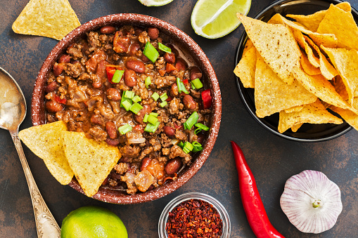 Mexican food dish chili con carne. The concept of Mexican cuisine. Top view, old, rusty background